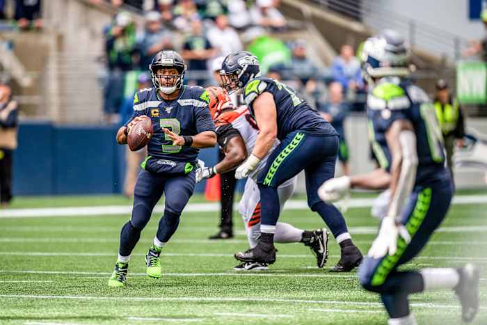 Russell Wilson escapes pressure and looks for DK Metcalf downfield
